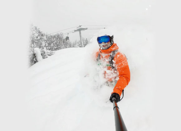 A skier wearing ski goggles with a blue lens