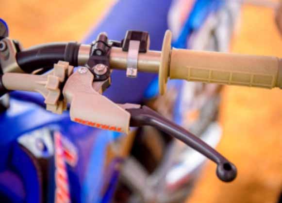 A motocross bike clutch next to a throttle