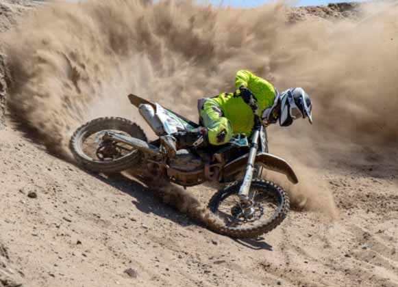 A motocross rider making a turn off-road