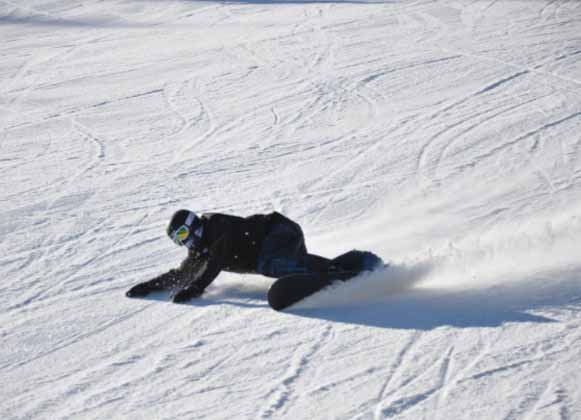 A snowboarder falling
